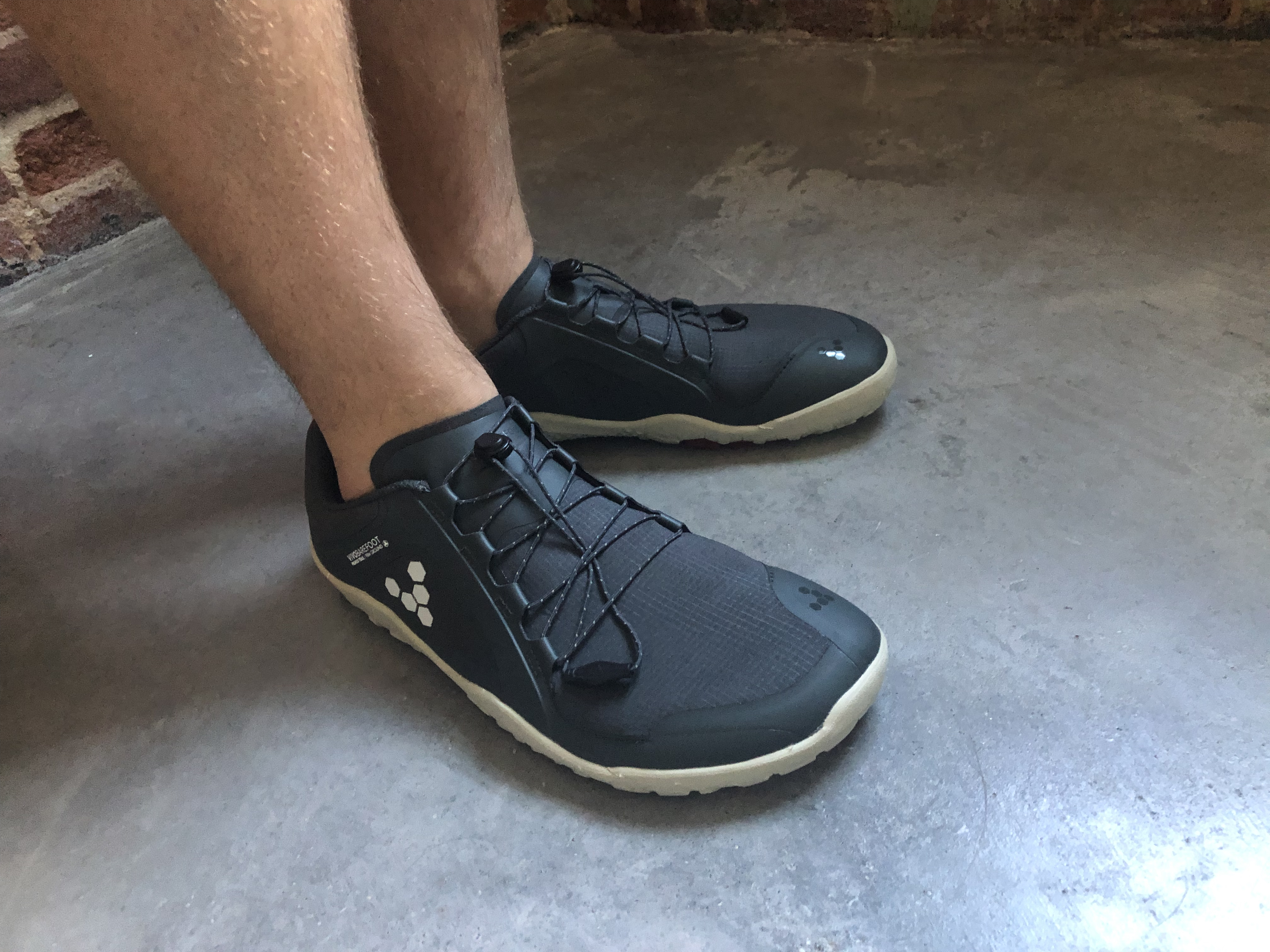 Photo of the shoes on my feet standing on concrete